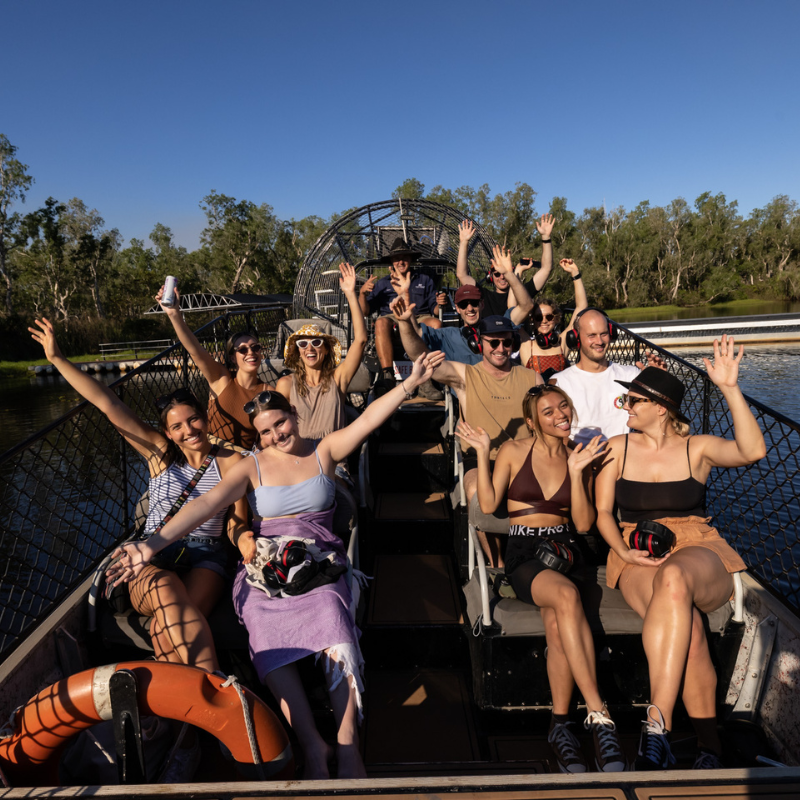 A cheerful group of people on an airboat and enjoying the ride